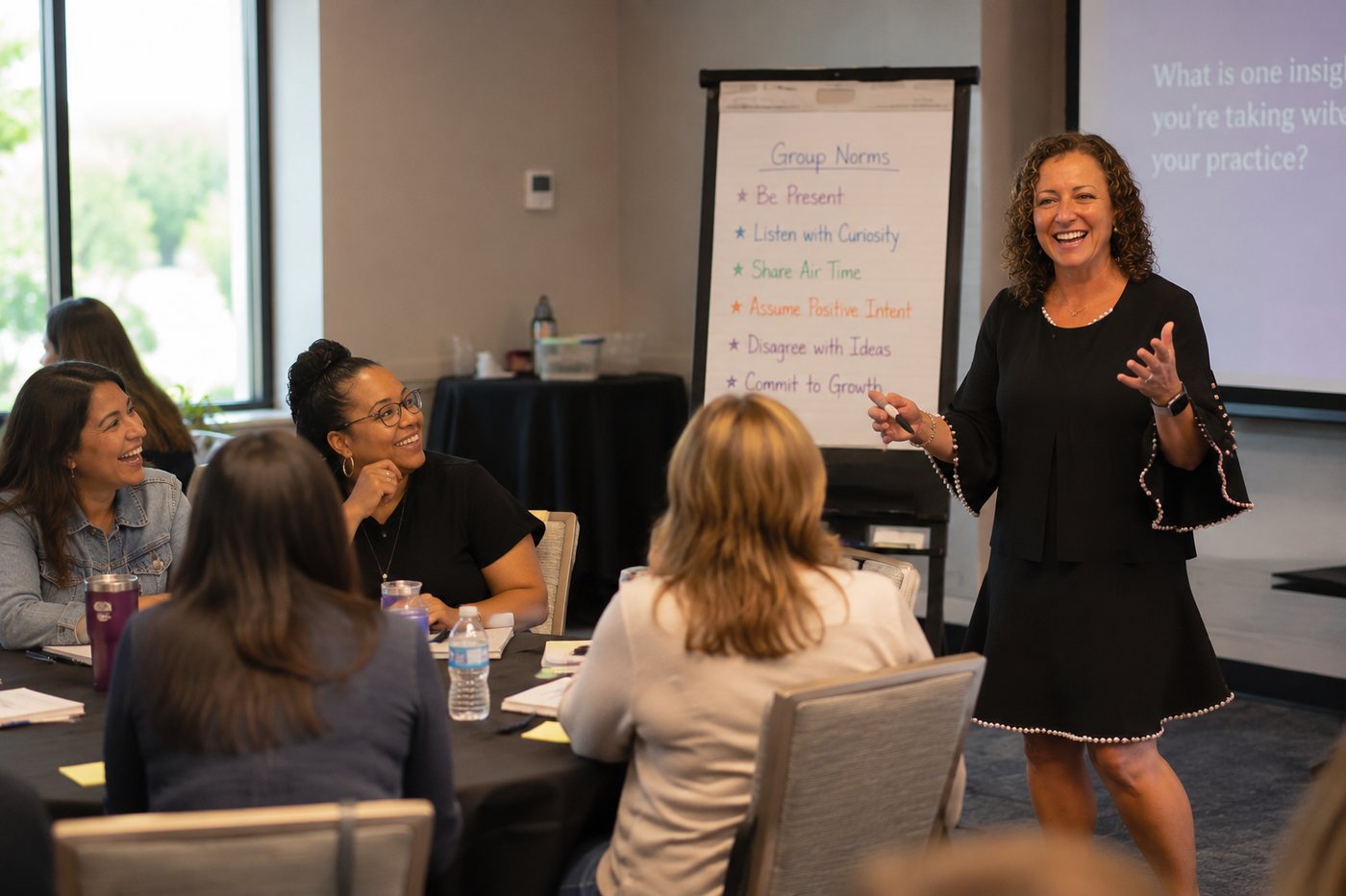 Dina Secchiaroli leading a professional learning session in front of a group of educators